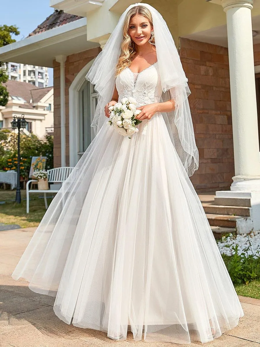 Robe de mariée A-ligne à encolure en V brodée à bretelles spaghetti